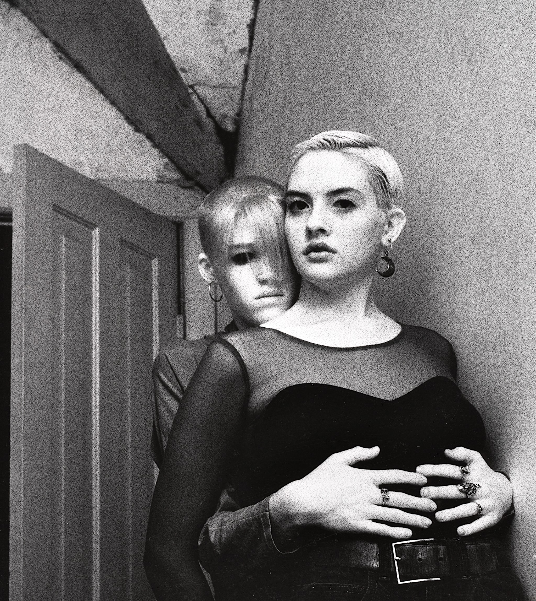 Two people embracing in an indoor portrait