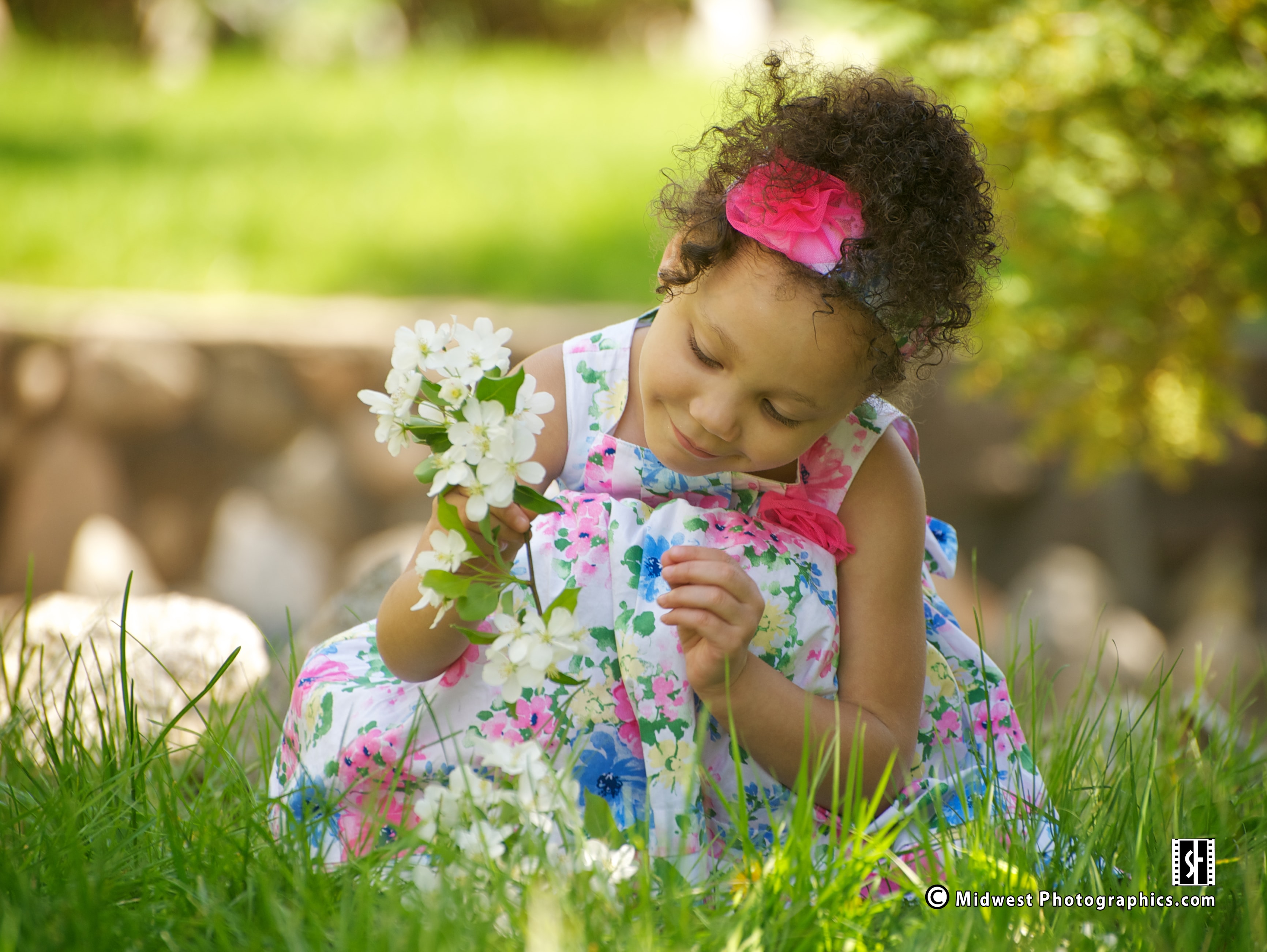 Girl holding flowers in a garden