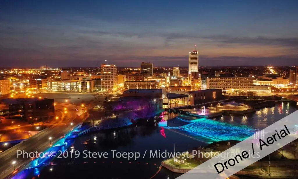 Nighttime drone aerial of city waterfront